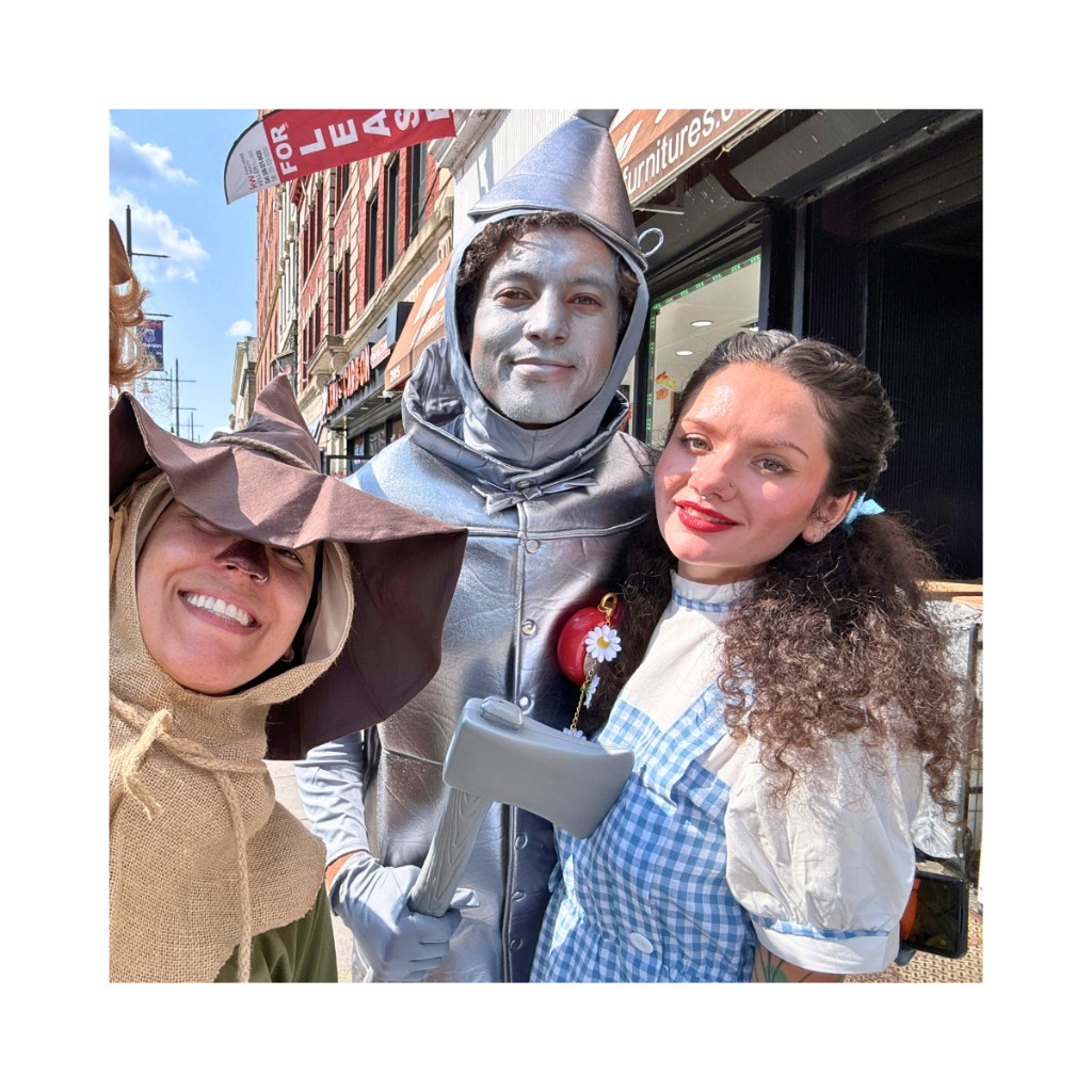 Three friends as the Scarecrow, Tin Man, and Dorothy posing for a selfie